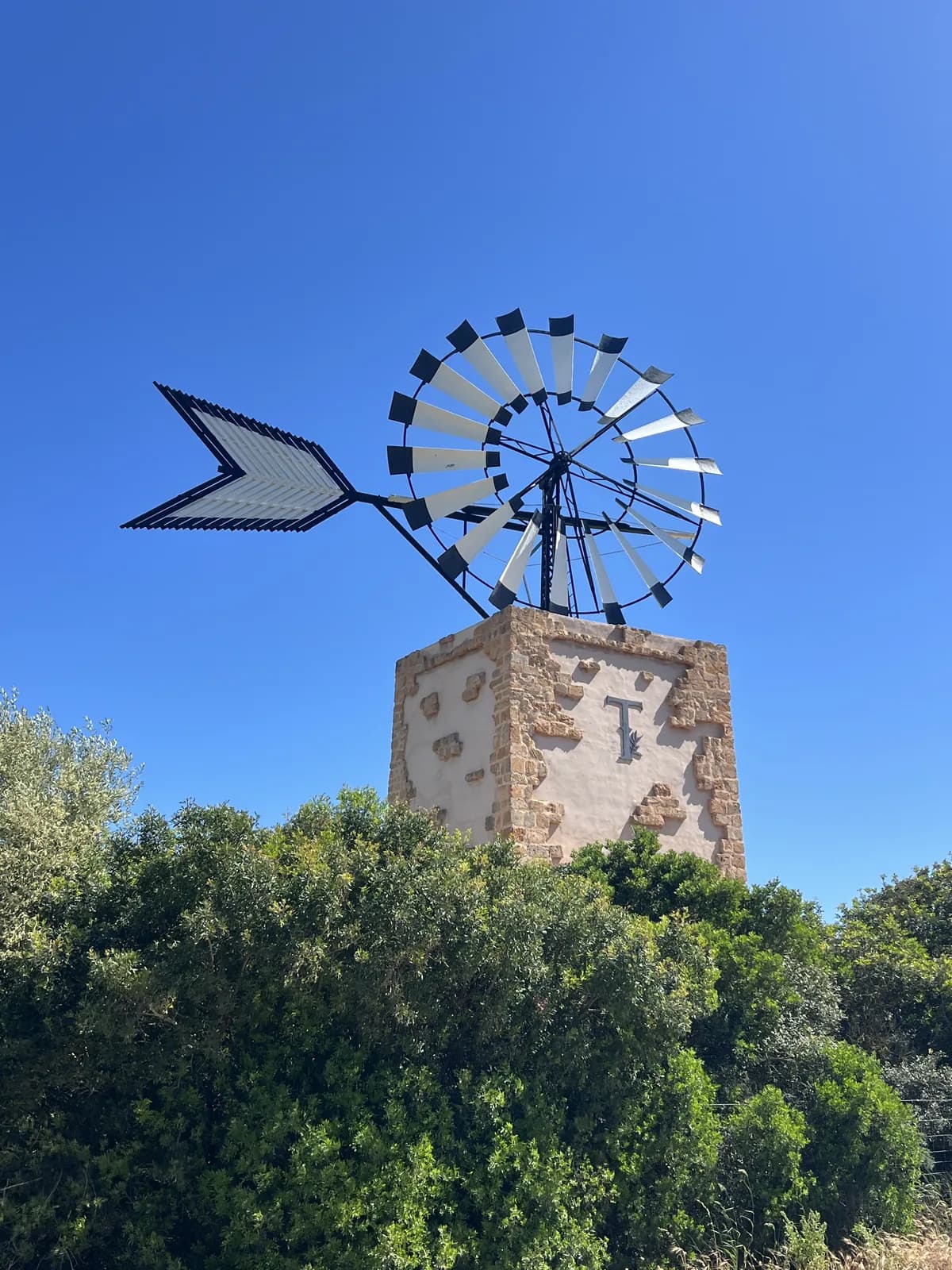 Windmill at T Golf Calvià against a clear blue sky