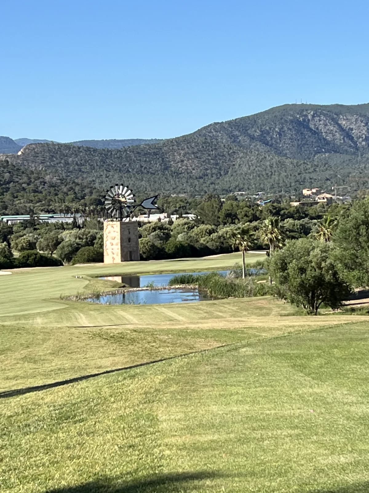 Fairway at T Golf Calvià with windmill and Tramuntana mountains in the background