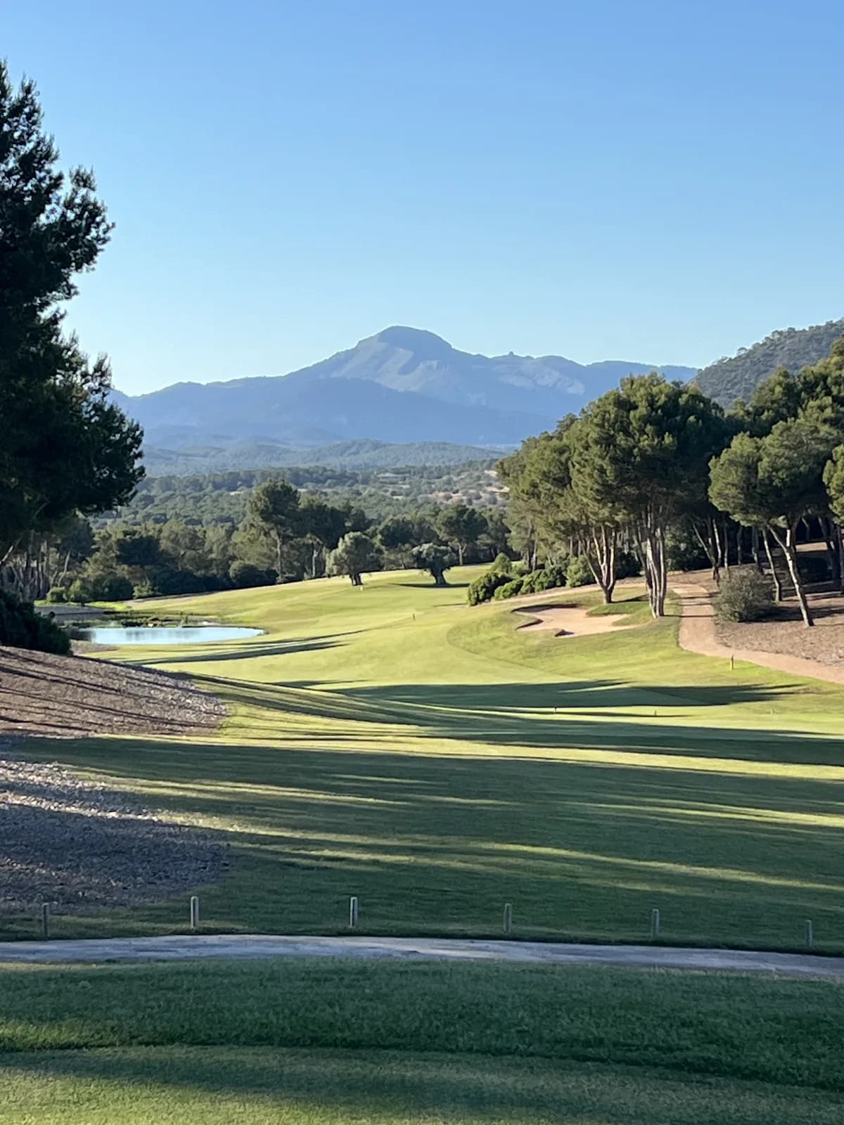 Fairway and bunkers at T Golf Calvià with the Tramuntana mountains in the background